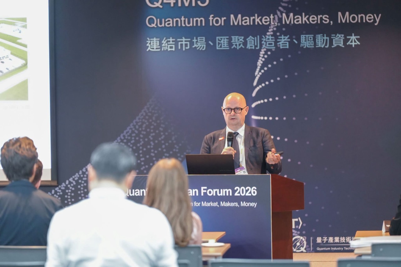A speaker addresses participants against the Q4M3 backdrop